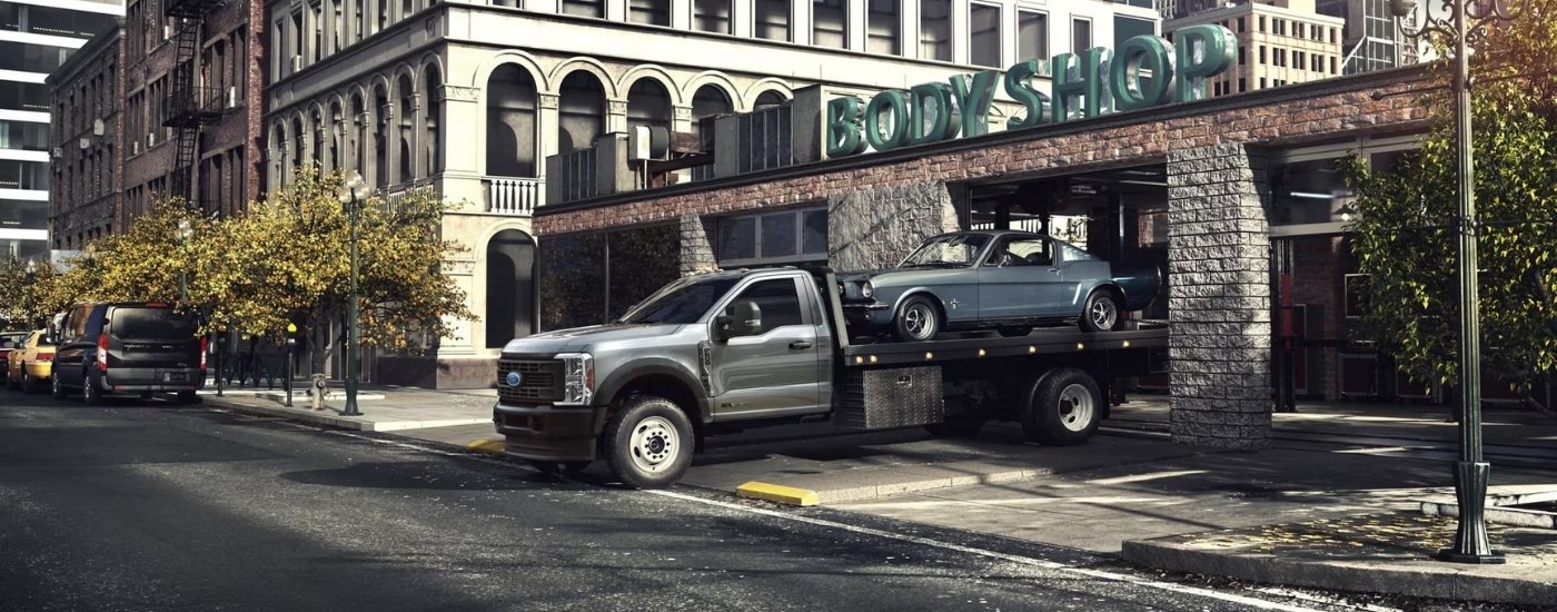 Grey 2023 Ford F-600 XL Chassis Cab at a body shop